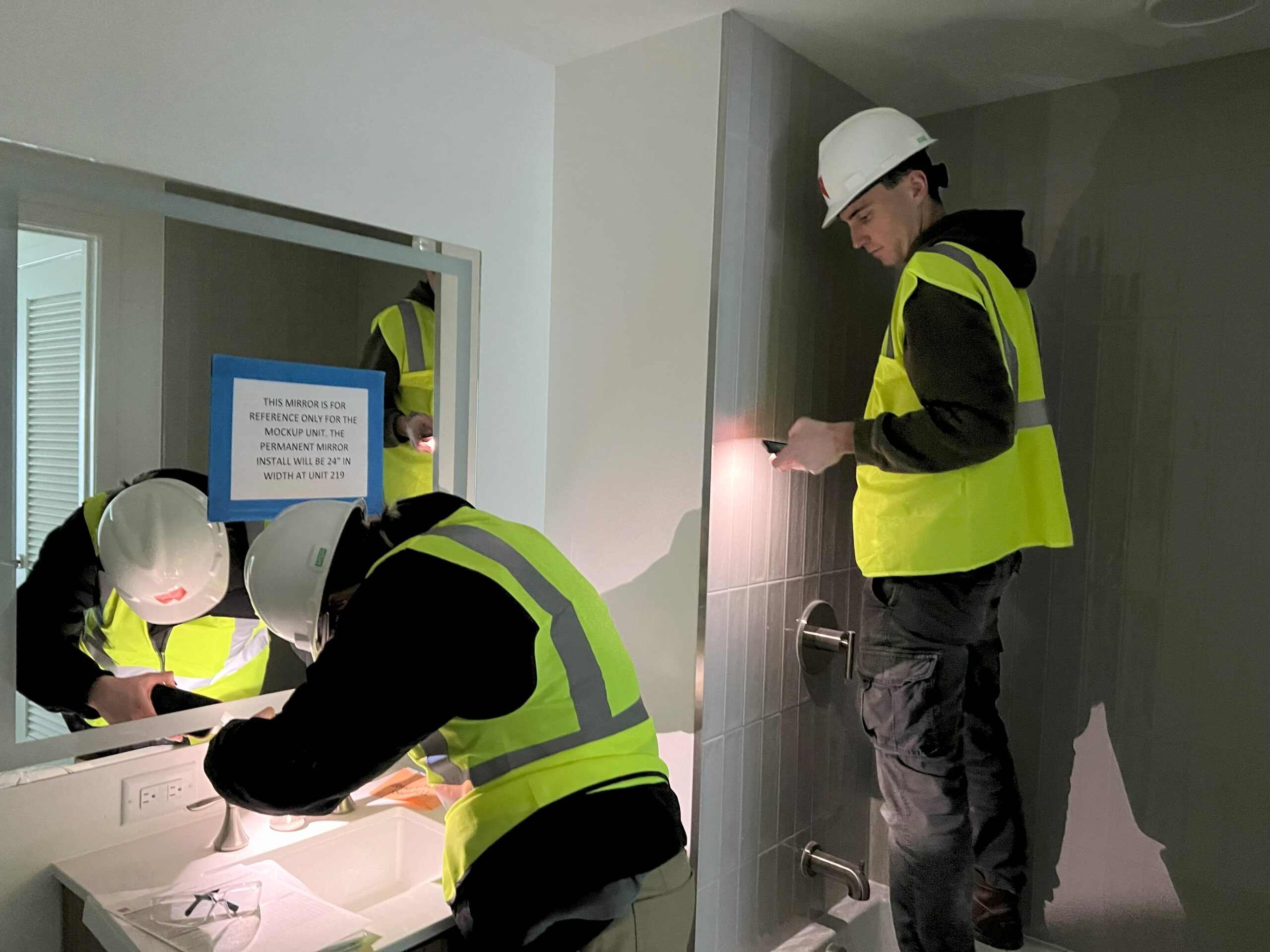 energy consultants inspecting a faucet