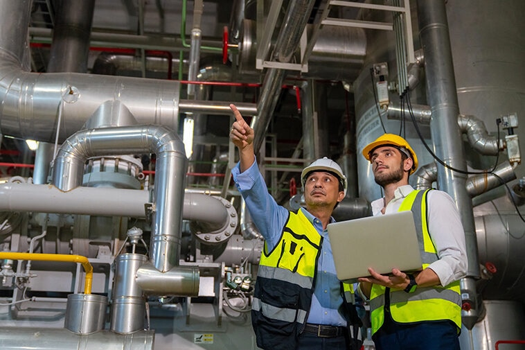 Two professional electrical engineer in safety uniform working t