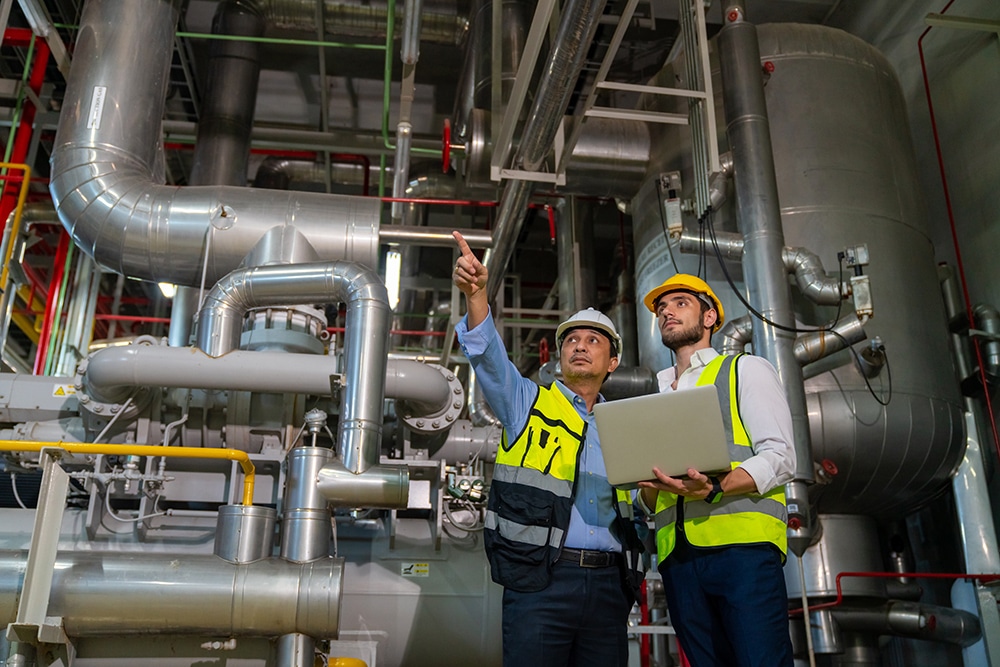 Two professional electrical engineer in safety uniform working t